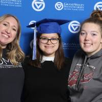 Three students pose together at GradFest